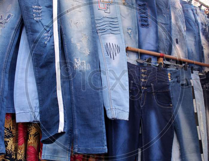 Variety of jeans pant cloths selling on a open shop at a busy market, at Esplanade, Kolkata.