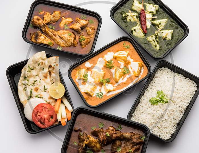 Indian Chicken & Mutton Curry With Paneer Butter Masala And Spinach Curry In Plastic Boxes For Home Delivery