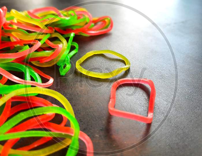 Closeup Of Rubber Bands On Workspace In Office Selective Focus