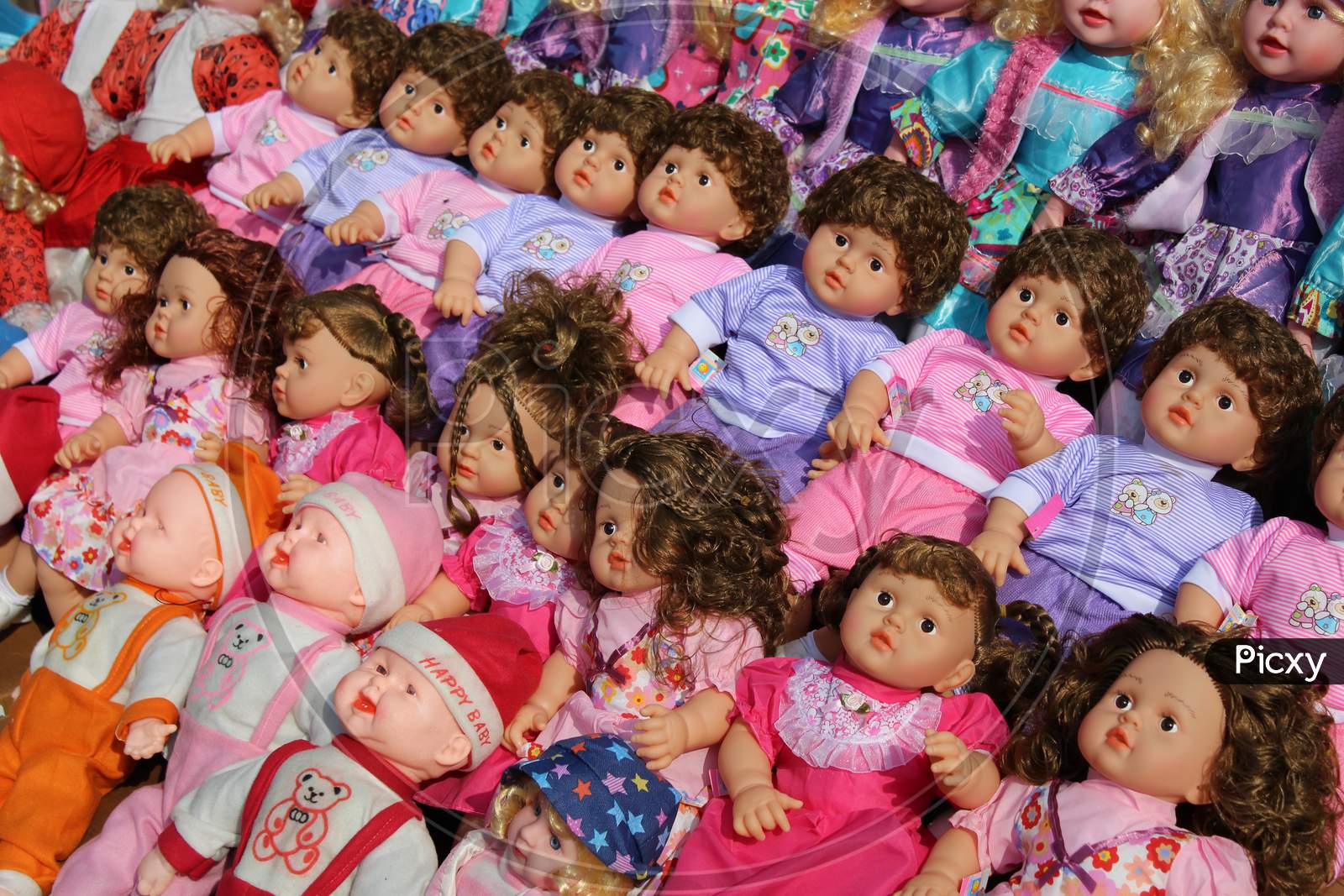 Variety of colorful dolls for kids selling on a open shop at a busy market, at Esplanade, Kolkata.