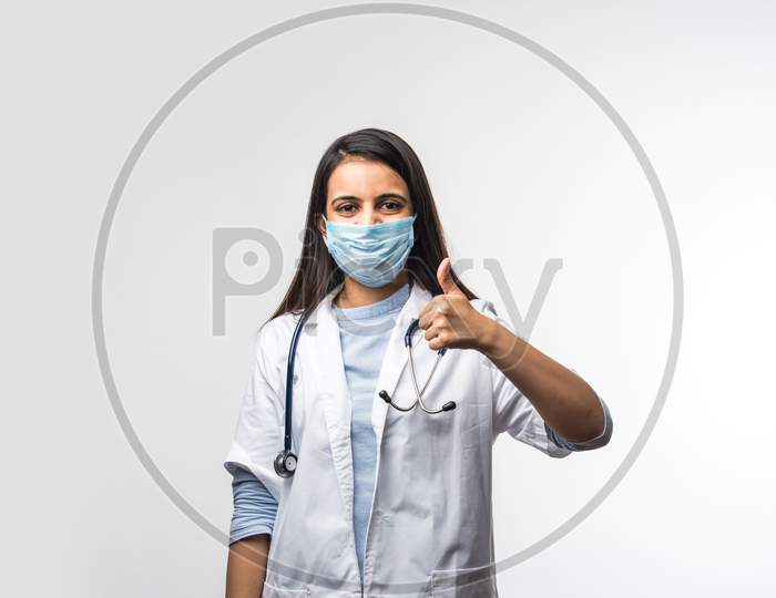 Pretty Indian Female Doctor In Uniform Wearing Medical Face Mask