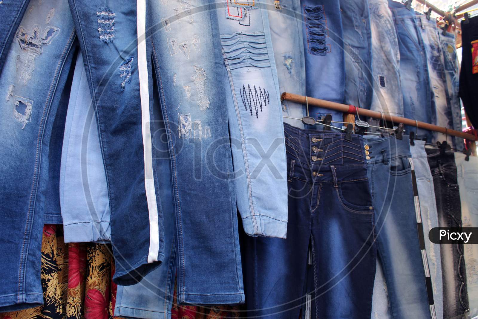 Variety of jeans pant cloths selling on a open shop at a busy market, at Esplanade, Kolkata.
