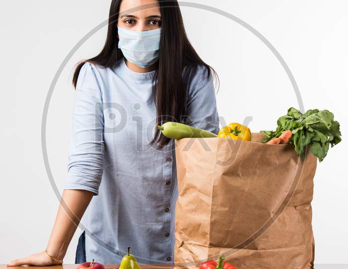 Pretty Indian Girl Or Woman Holding Bag With Vegetables And Fruits