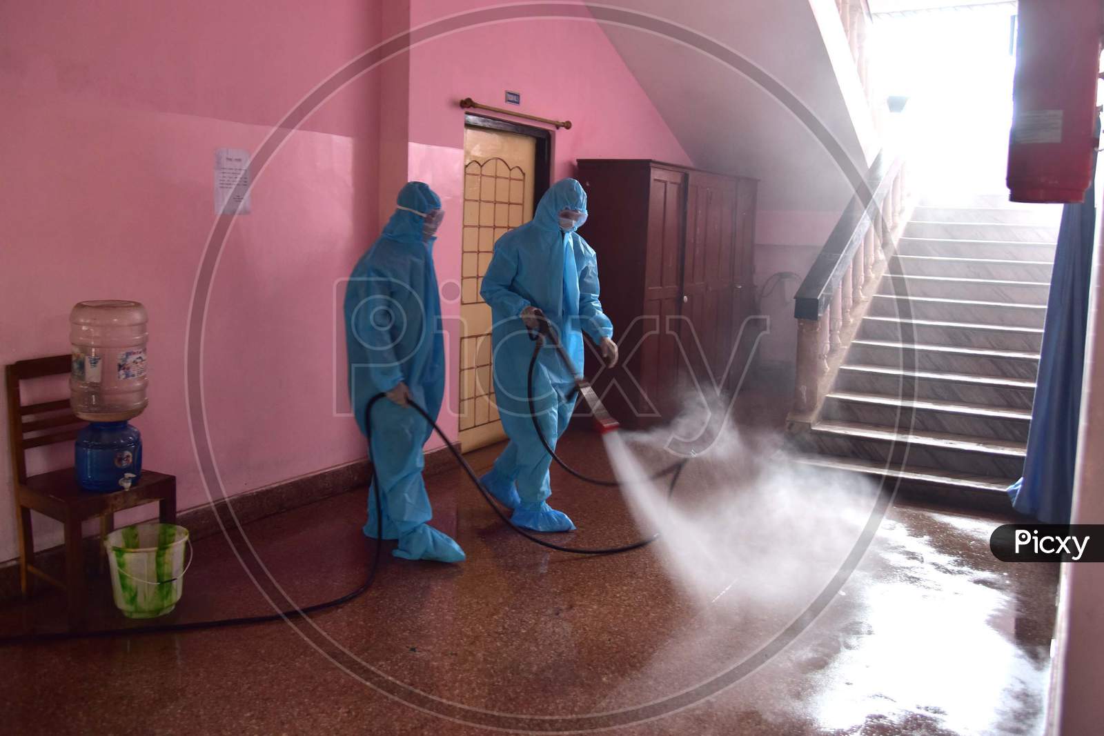 Firefighters wearing hazmat suits spray disinfectant in judicial courts after reports of five staff members who tested positive for Coronavirus in Nagaon, Assam on July 03, 2020.