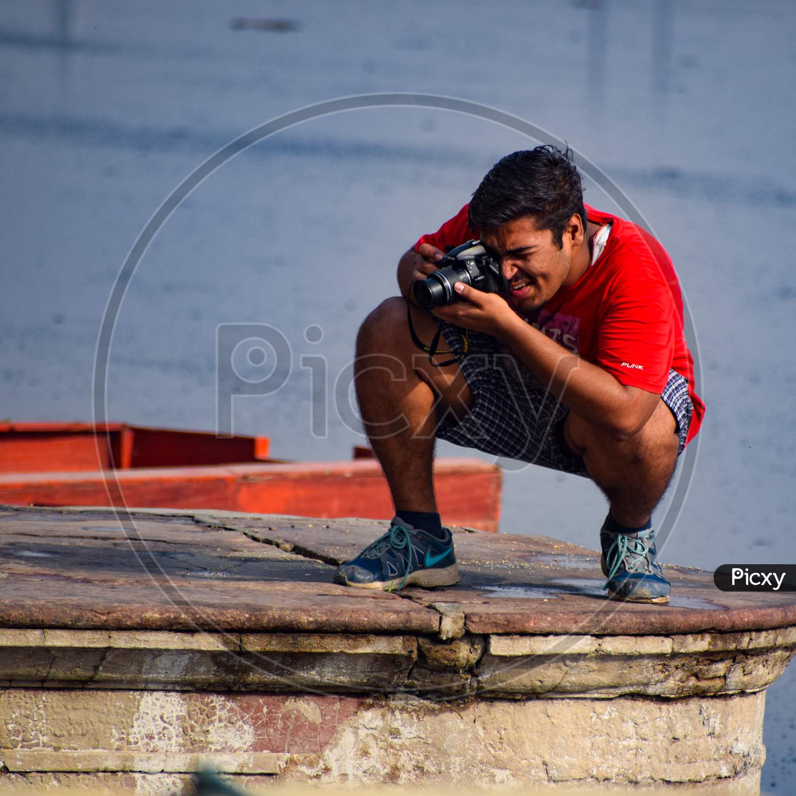 Delhi, India - Dec 31, 2019 : Man taking bath in holy river of Yamuna during morning time in Delhi India, People taking holy dip inside Yamuna river