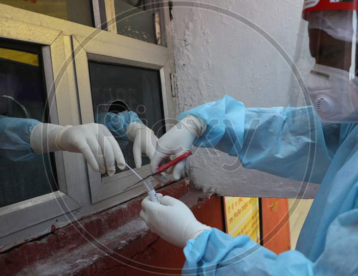 Health workers store a  swab sample from a patient at a Government Hospital for Covid-19 test in Jammu on July 03, 2020