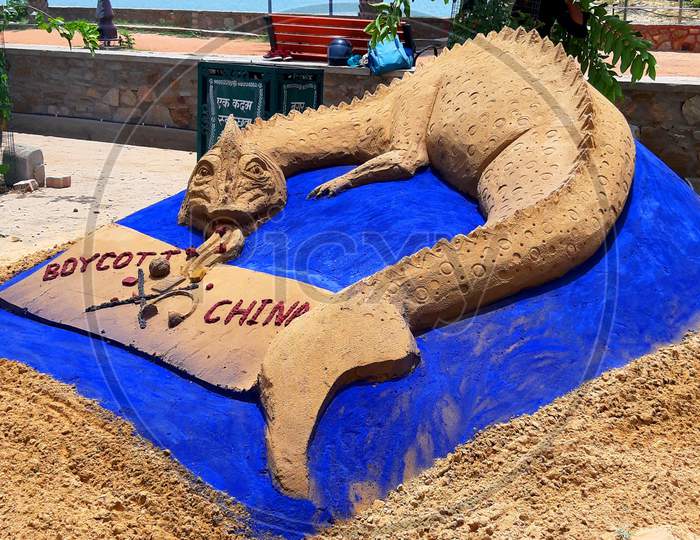 Sand artist Ajay Rawat creates a sculpture to support the "Boycott China Product" movement in Ajmer, India on July 03, 2020
