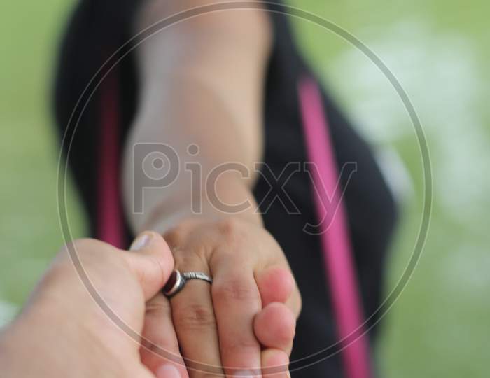 Man holding girl's hand