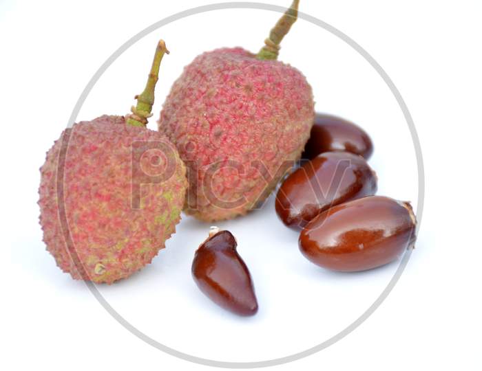 the red ripe litchi with brown beans isolated on white background.