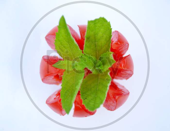 the red tomato with green mint isolated on white background.