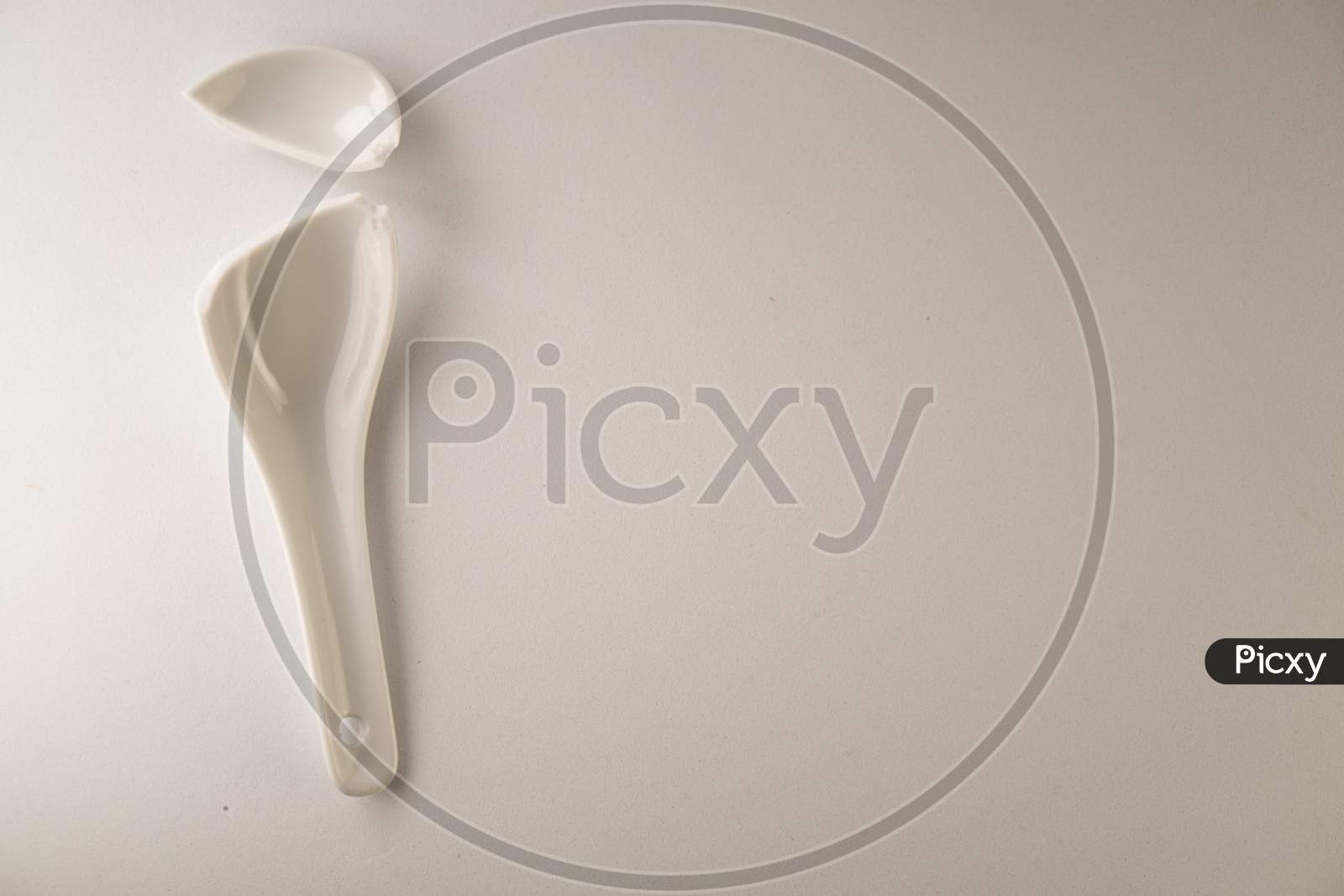 Broken white ceramic spoon on a white background