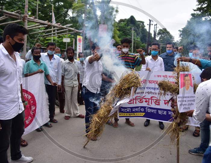 Members of All Assam Students Union(AASU) burn the effigy of Union Petroleum Minister Dharmendra Pradhan and Assam Food and Civil Supplies Minister Phani Bhusan Choudhury to protest against the price hike of fuel and essential commodities in Nagaon, Assam on July 03, 2020.