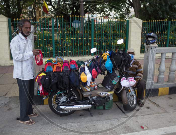 Mask vendor on a moto scooter in Mysore/Karnataka/India.