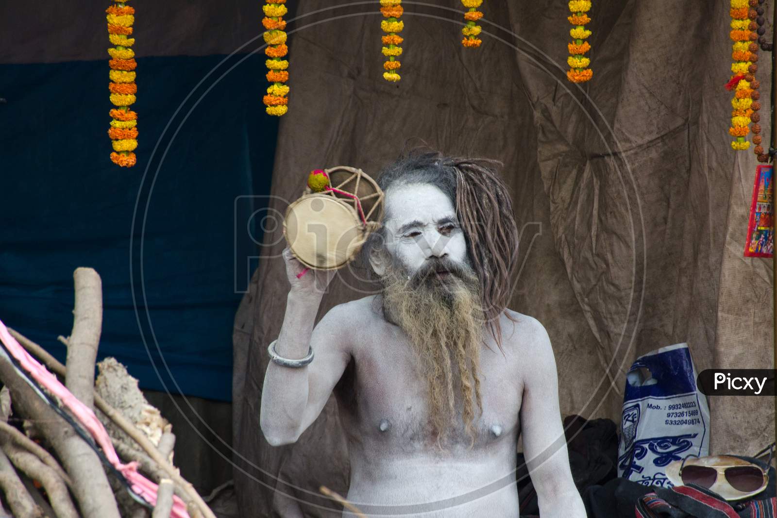 naga sadhu playing damru