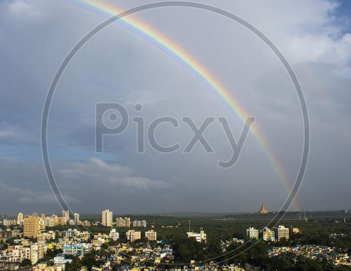 Potrait Shot Of Rainbow In India ,Maharashtra In Mumbai City Near Gorai Beach With Golden Temple Pagoda In The Frame