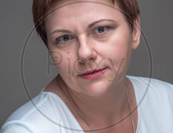Portrait Of Woman With Confused, Surprised Expression And Eyes Wide Open.