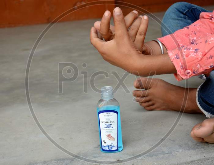 a boy sanitizing hand