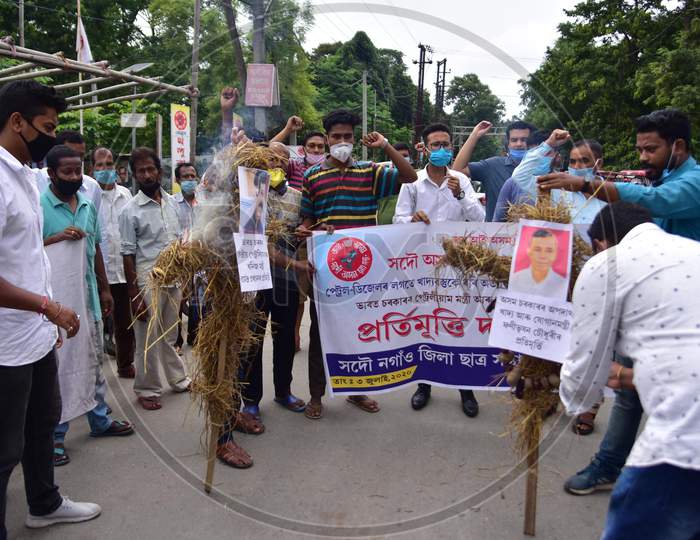 Members of All Assam Students Union(AASU) burn the effigy of Union Petroleum Minister Dharmendra Pradhan and Assam Food and Civil Supplies Minister Phani Bhusan Choudhury to protest against the price hike of fuel and essential commodities in Nagaon, Assam on July 03, 2020.