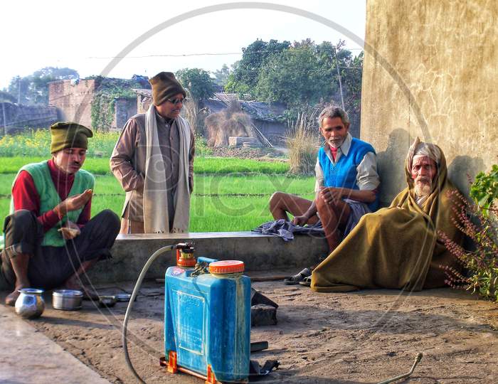 Farmers relaxing in leisure time after working in farm