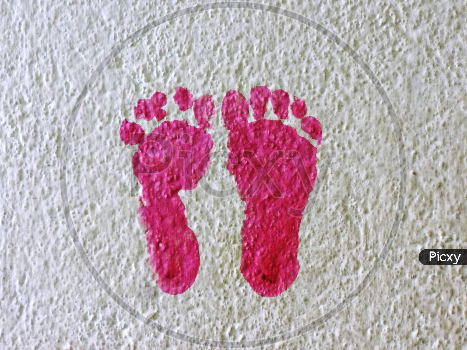 Knitting pink baby foot print on the wall