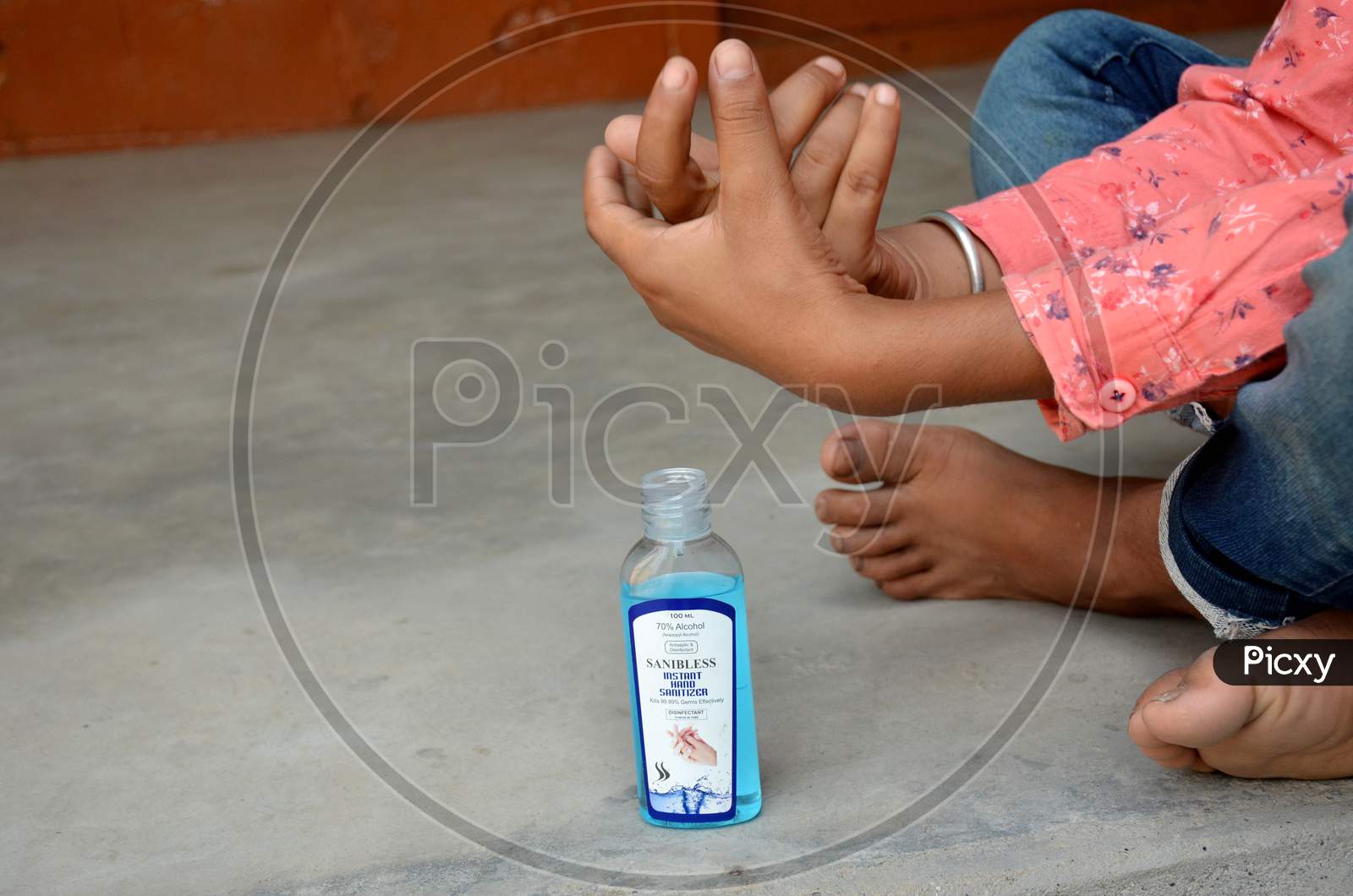 a boy sanitizing hand