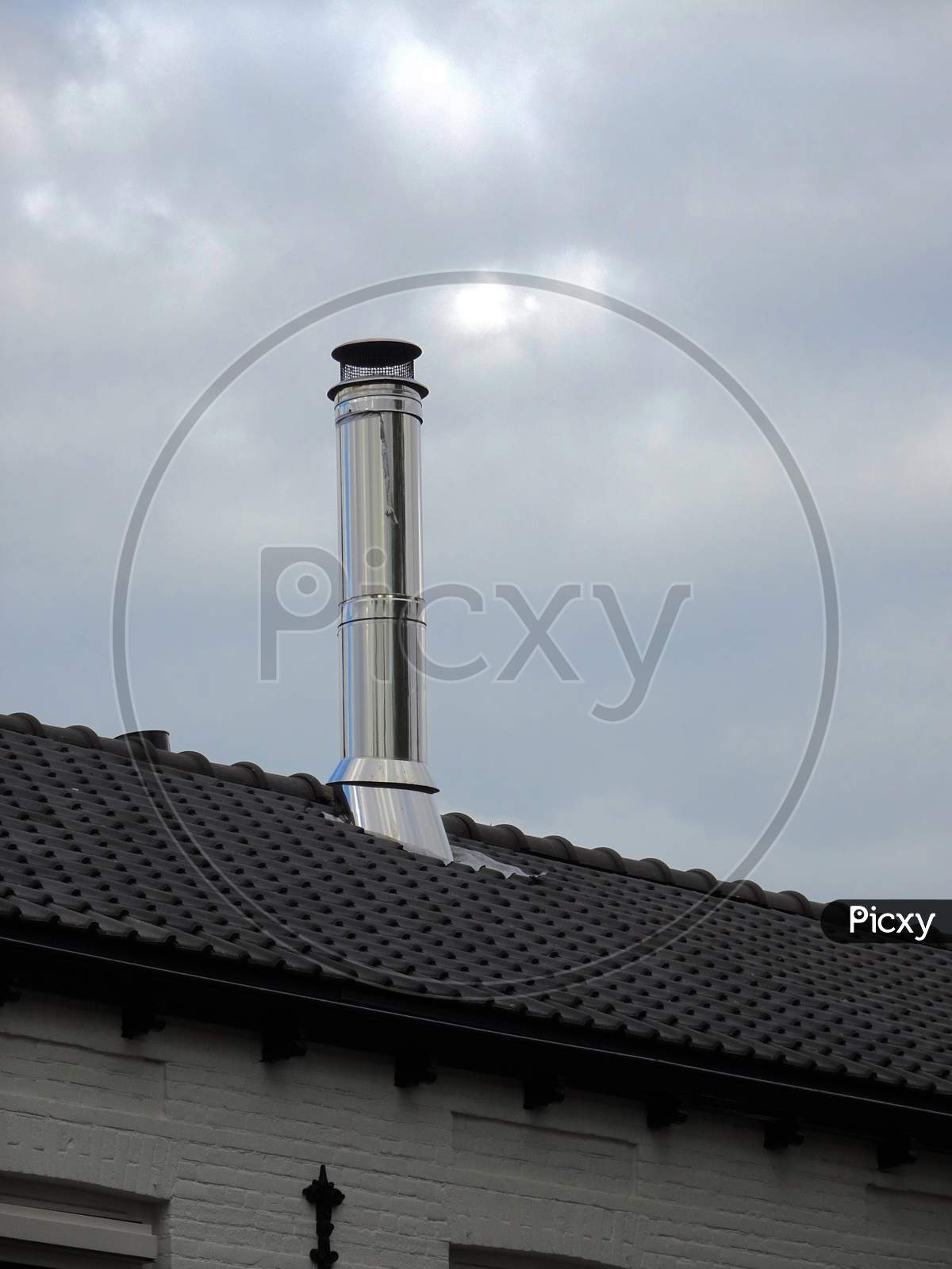 Stainless steel large chimney on the rooftop