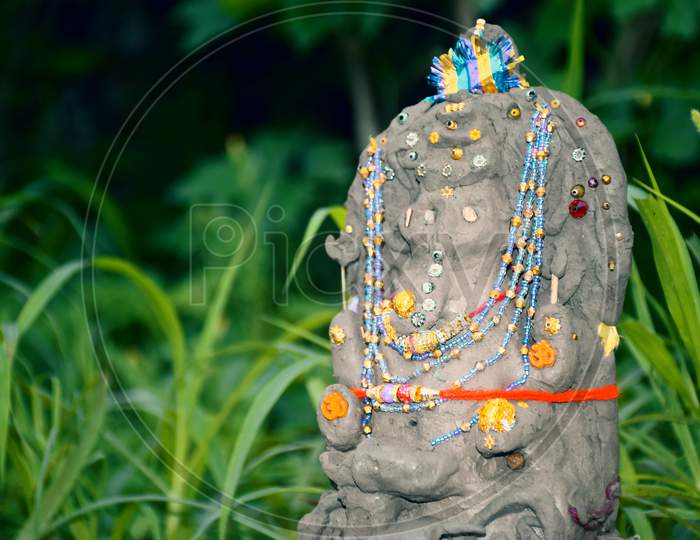 Lord Ganesha In Selective Focus, Made Of Clay With Background, In Indian Village