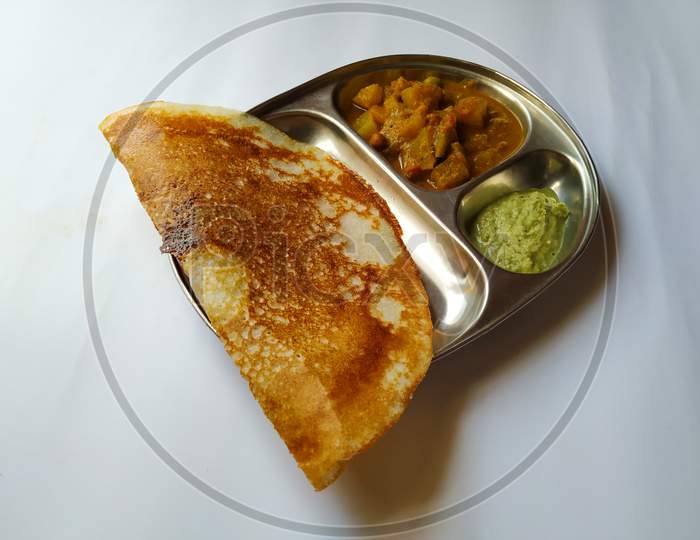 Indian Breakfast Tasty Masala Dosa with Coconut Chutney and Vegetable Saagu in a Plate isolated on white Background