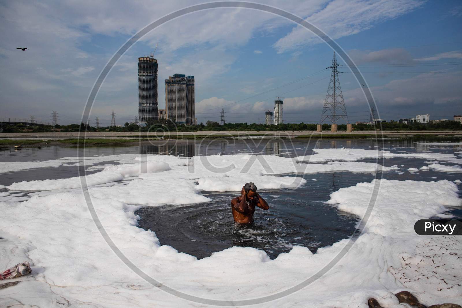 A Man Takes A Dip In The Polluted Waters Of The Yamuna River On July 30, 2020 In New Delhi, India.