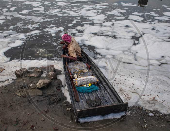 Indian Fisherman Uses A Fishing Net In The Polluted Water Of The Yamuna River On July 30, 2020 In New Delhi, India.