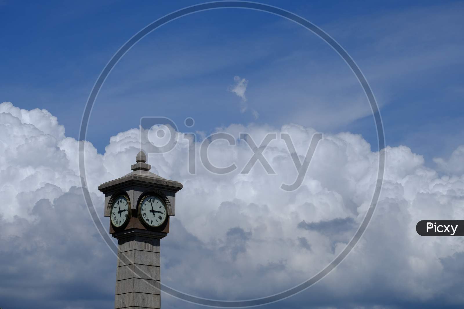 Isolated Clock Tower With Blue Sky And Cloud In Background, Copy Space