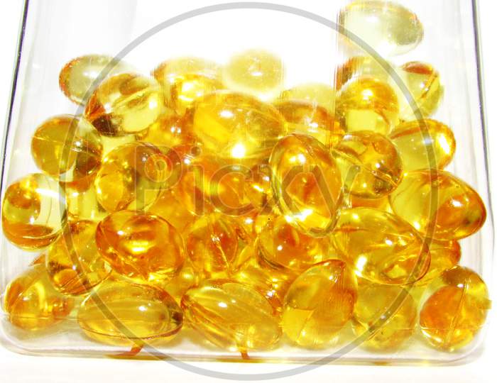 Cod liver oil  or fish oil gel capsules in jar on white  background.