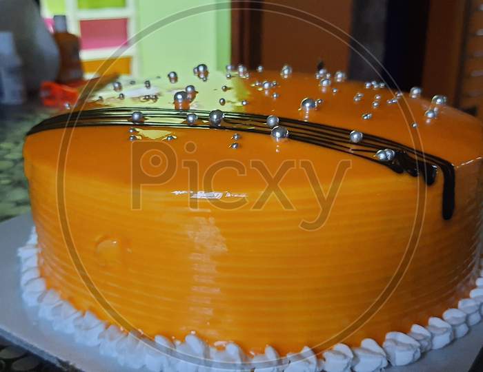 Mango flavour mirror glazior cake