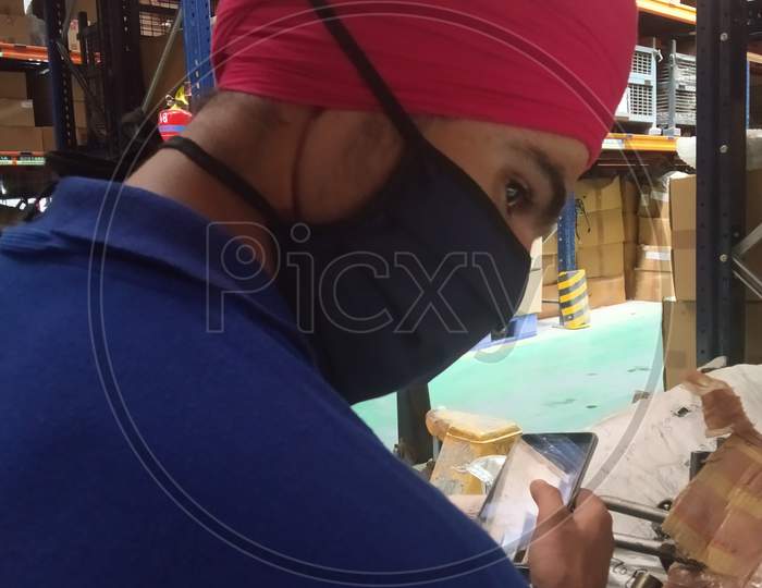 The sardar ji used phone with wearing mask to protect covid-19