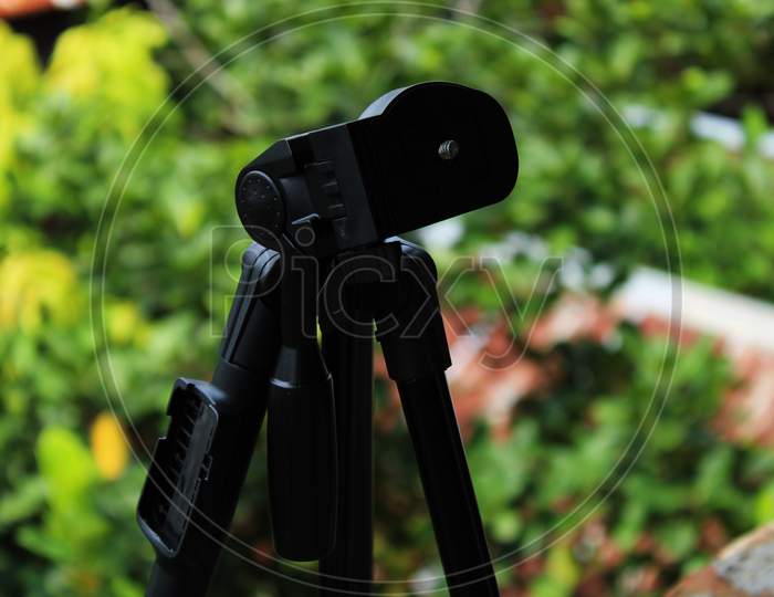 Black color camera tripod photo