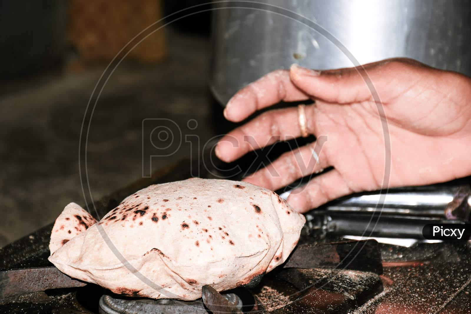 Woman'S Hand Bread Roasted On Lpg