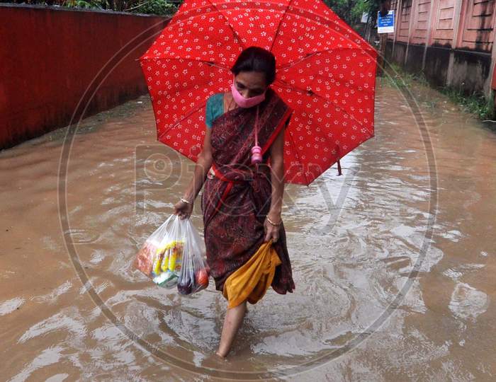 A Woman Wades Through A Waterlogged Street After Rains  In Guwahati On July 30,2020