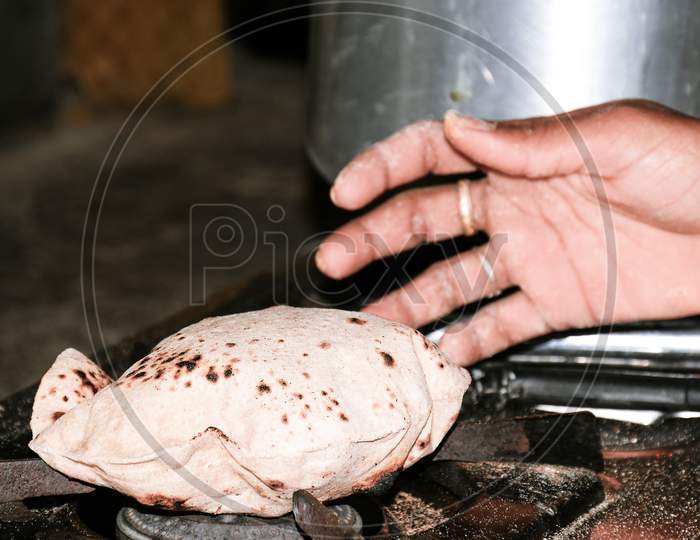 Woman'S Hand Bread Roasted On Lpg