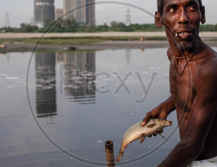 An Indian Fisherman Seen Fishing In The Polluted Waters Of The Yamuna River On July 30, 2020 In New Delhi, India.
