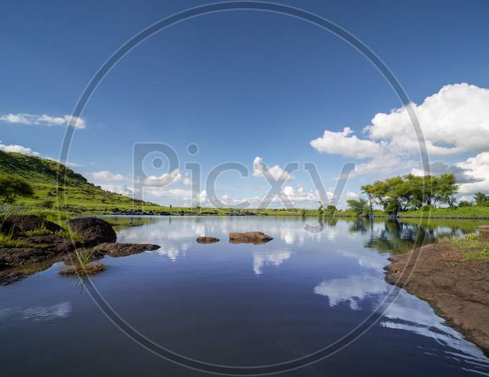 Hill side lake view with blue sky