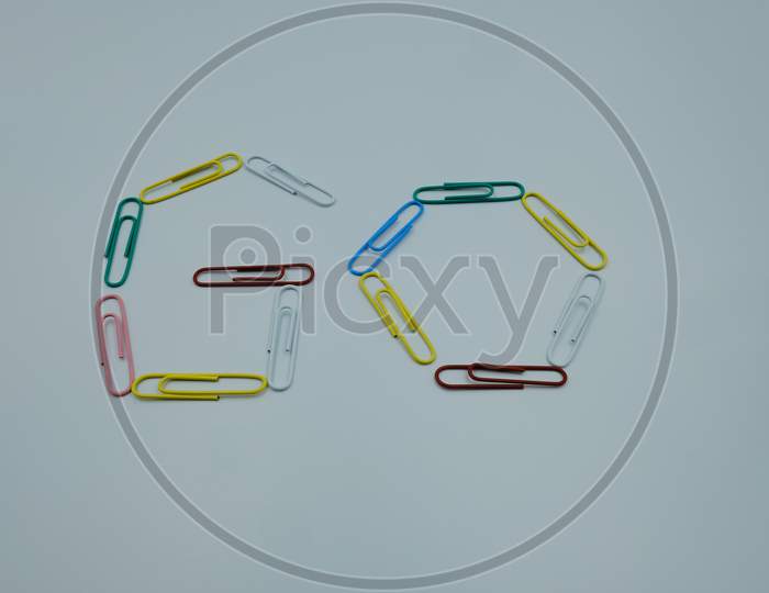 Text Letter Go By Paper Clips Multicolor On White Background