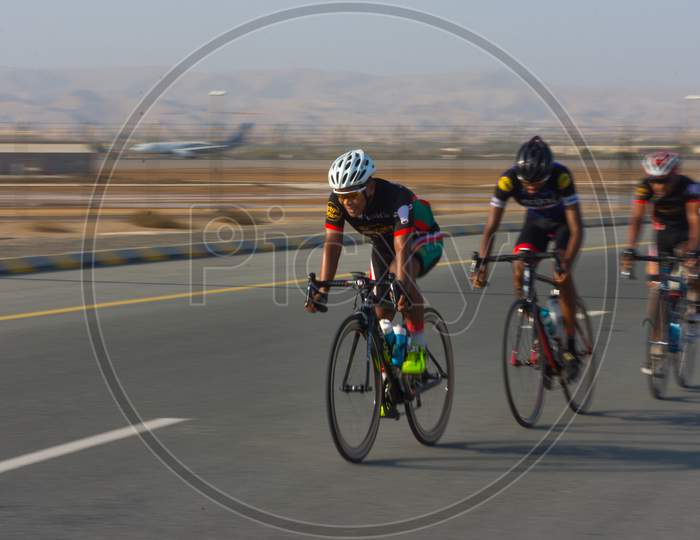 Muscat,Oman 15Th September 2017. Bicycle Racers Riding On The Road Racing Track To Win The Race.