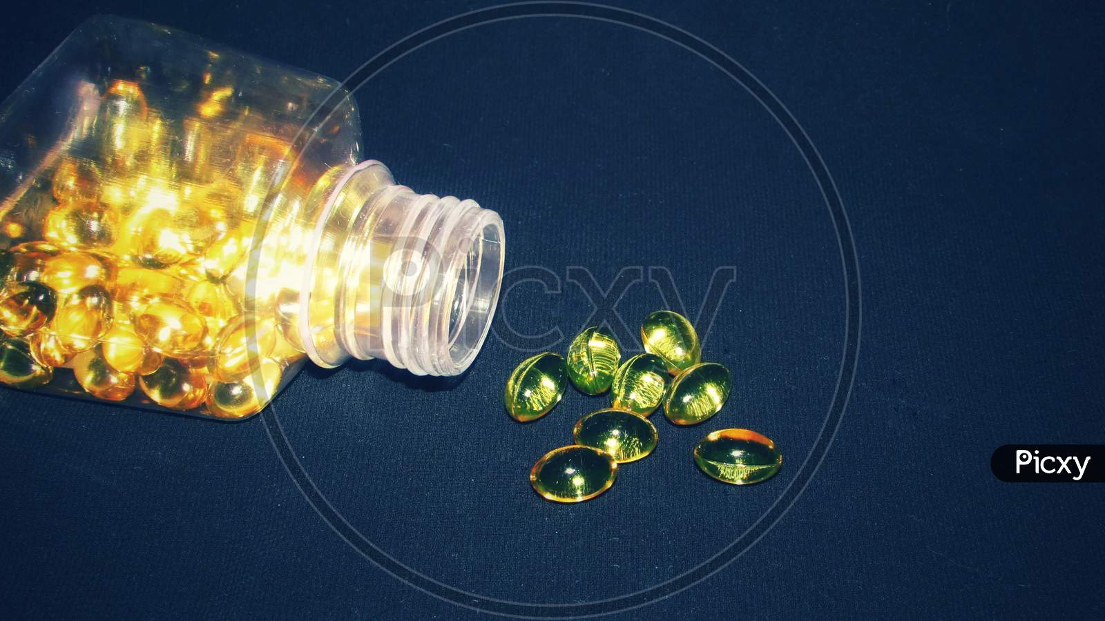 Cod liver oil  or fish oil gel capsules in jar and outside on black  background.