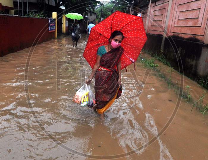 A woman Wades Through A Waterlogged Street After Heavy Rainfall  In Guwahati On July 30, 2020.