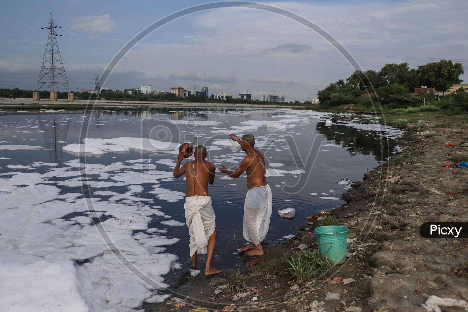 Hindu Devotees Throw Religious Offerings In River Yamuna On July 30, 2020 In New Delhi, India.