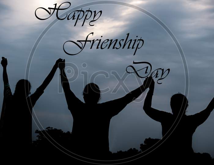 silhouette of friends with hands up (Happy friendship Day)