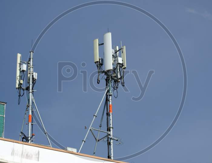 Telecommunication Pole Of 3G, 4G, 5G Cellular Antenna, Small Cell Site Base Station On The Rooftop Of The Building