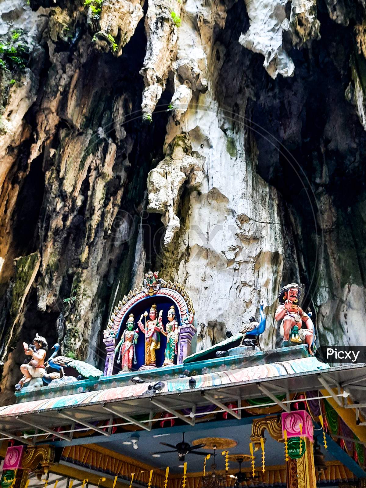 Beautiful Natural Limestone Cave In Malaysia. Entrance To Dark Cave From A Huge Hollow Feature. One Of Main Caves Located In Batu Caves Hill. Kuala Lumpur Malaysia