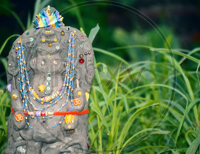 Lord Ganesha In Selective Focus, Made Of Clay With Background, In Indian Village