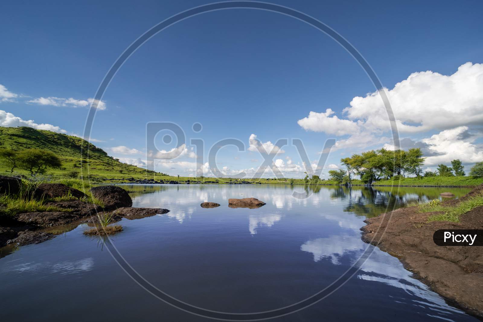 Hill side lake view with blue sky